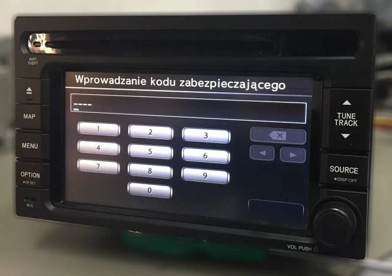 Ekran nawigacji Honda QY-5017H z prośbą o wpisanie 4-cyfrowego kodu zabezpieczającego w celu odblokowania.